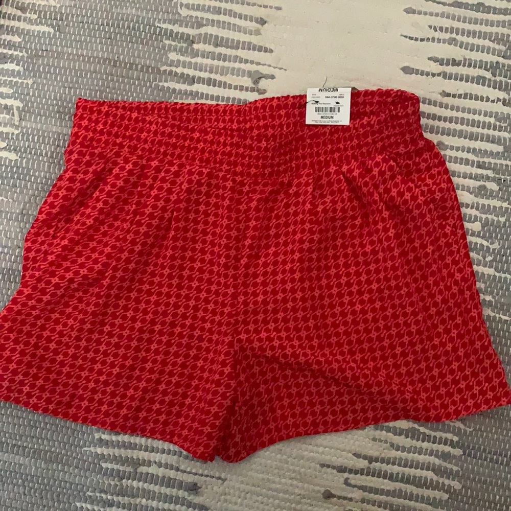 Never worn, coral and red patterned shorts.